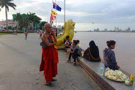 Monks walking near Wat Phnom during early morning rituals